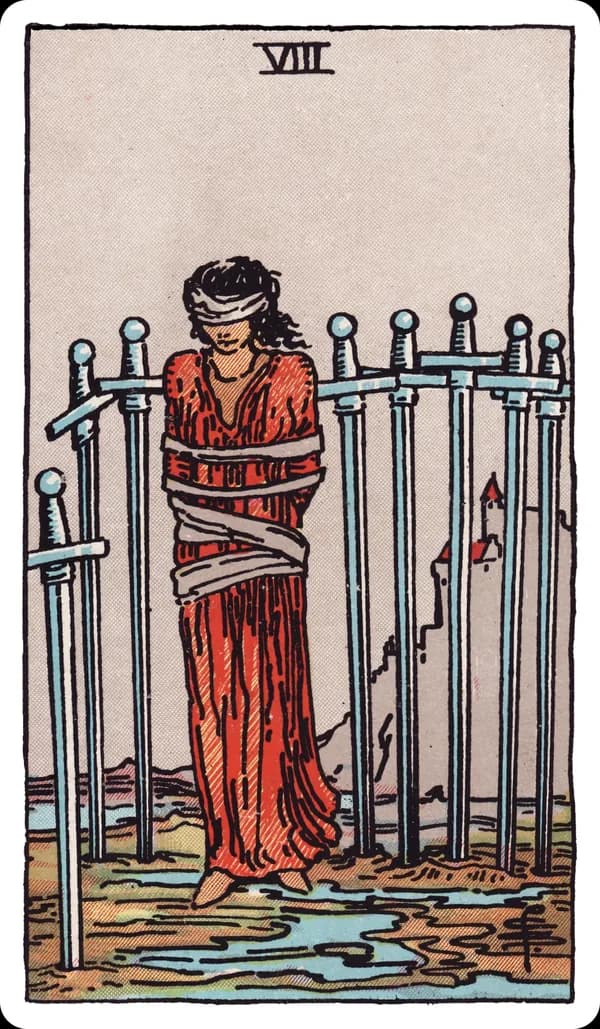 The Eight of Swords from the Rider-Waite-Smith deck: a woman stands blindfolded and loosely bound, surrounded by eight swords planted upright in the muddy ground around her forming a loose, incomplete cage, a castle visible on a hill in the distance, the ground beneath her feet clear of any barrier.