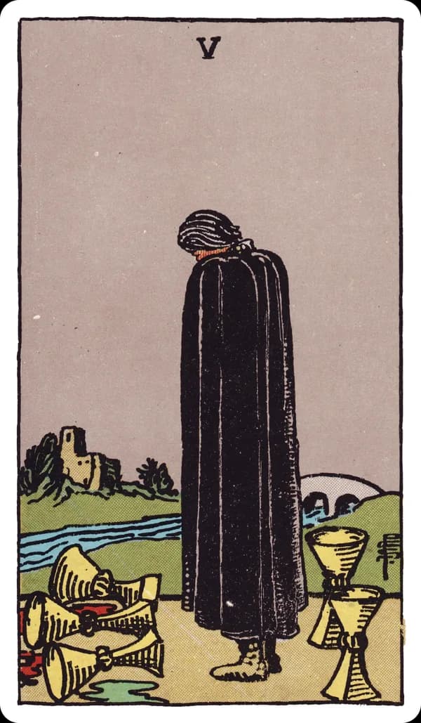 The Five of Cups from the Rider-Waite-Smith deck: a figure in a black cloak stands with head bowed before three overturned cups spilling dark liquid onto the ground, while two upright cups stand untouched behind him; a river and a distant bridge leading to a castle complete the scene.