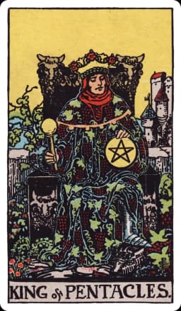 The King of Pentacles from the Rider-Waite-Smith deck: a king sits on a throne carved with bulls' heads and grapevines, richly robed in vine-patterned fabric, holding a scepter in one hand and a large pentacle balanced on his knee, a castle in the distance and lush vineyards surrounding his throne.