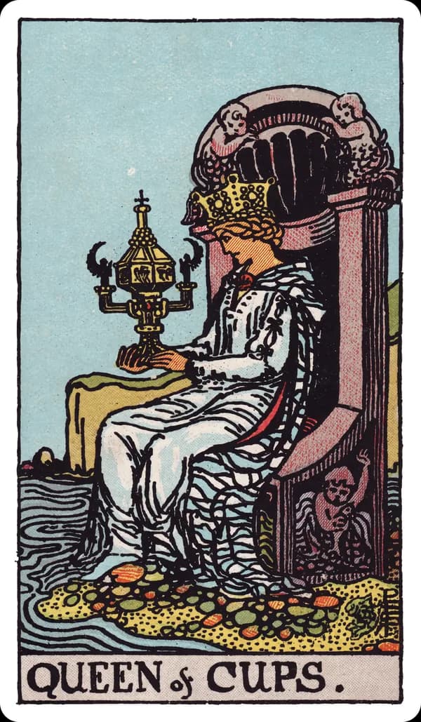 The Queen of Cups from the Rider-Waite-Smith deck: a queen sits on an ornate throne carved with mermaids and shells at the edge of a calm sea, her feet nearly touching the water, gazing intently at a large, closed, elaborately decorated golden cup held in both hands.