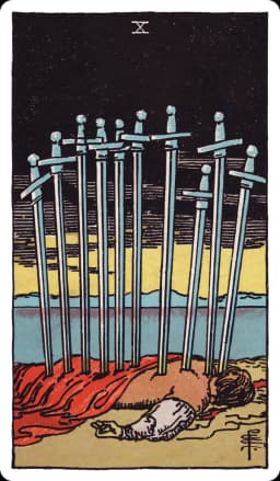 The Ten of Swords from the Rider-Waite-Smith deck: a man lies face down on the ground, ten swords piercing his back in a straight line from shoulders to legs, a dark red cloak beneath him, a black sky above giving way to a bright yellow sunrise breaking calmly over distant hills and water on the horizon.