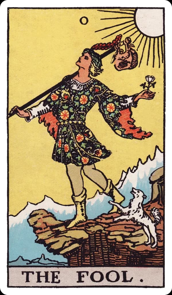 The Fool from the Rider-Waite-Smith deck: a young traveler in bright clothing steps toward a cliff edge with a small white dog at his heels, a bindle on a stick over his shoulder, facing a sunlit mountain range, apparently unaware of the drop just ahead.