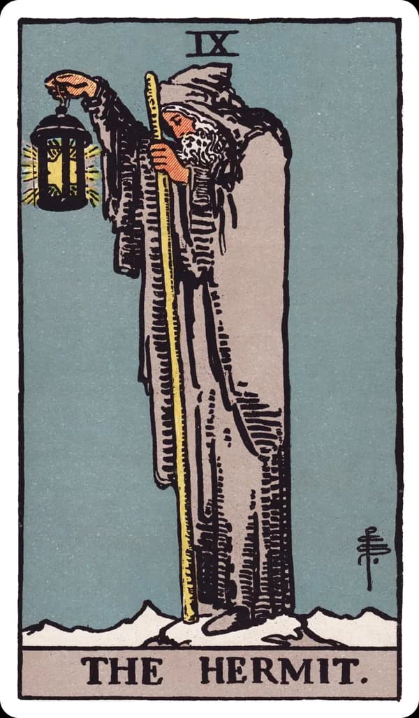 The Hermit from the Rider-Waite-Smith deck: an old, grey-bearded man in a hooded grey cloak stands alone on a snowy mountain peak, holding a lantern containing a six-pointed star high in one raised hand and a long wooden staff in the other, looking downward as if lighting the way for someone unseen behind him.