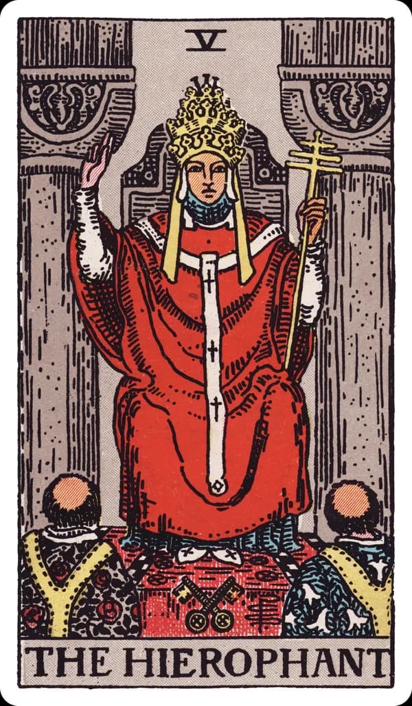 The Hierophant from the Rider-Waite-Smith deck: a robed figure wearing a triple-tiered papal crown sits enthroned between two grey pillars, right hand raised in a two-fingered gesture of benediction, a triple-barred cross staff in his left hand, two crossed keys resting at the base of his throne, and two tonsured acolytes kneeling before him, their robes patterned with lilies and roses.